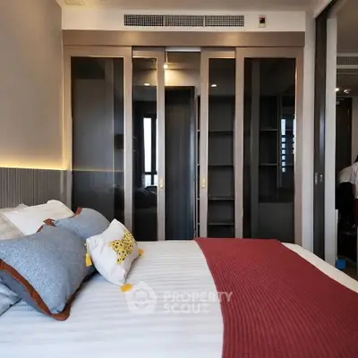 Luxurious bedroom with modern sliding glass closet doors and stylish decor