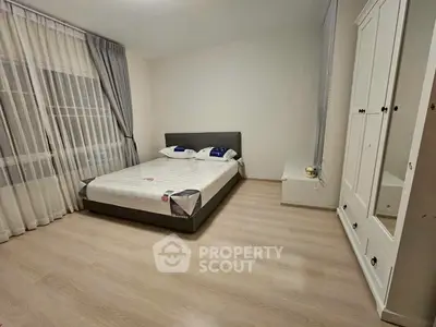 Spacious bedroom with modern decor and ample natural light