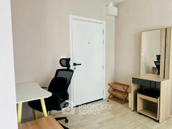 Modern study room with sleek desk, ergonomic chair, and stylish mirror cabinet.