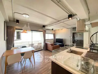 Spacious modern living room with open kitchen and dining area, featuring large windows and stylish decor.