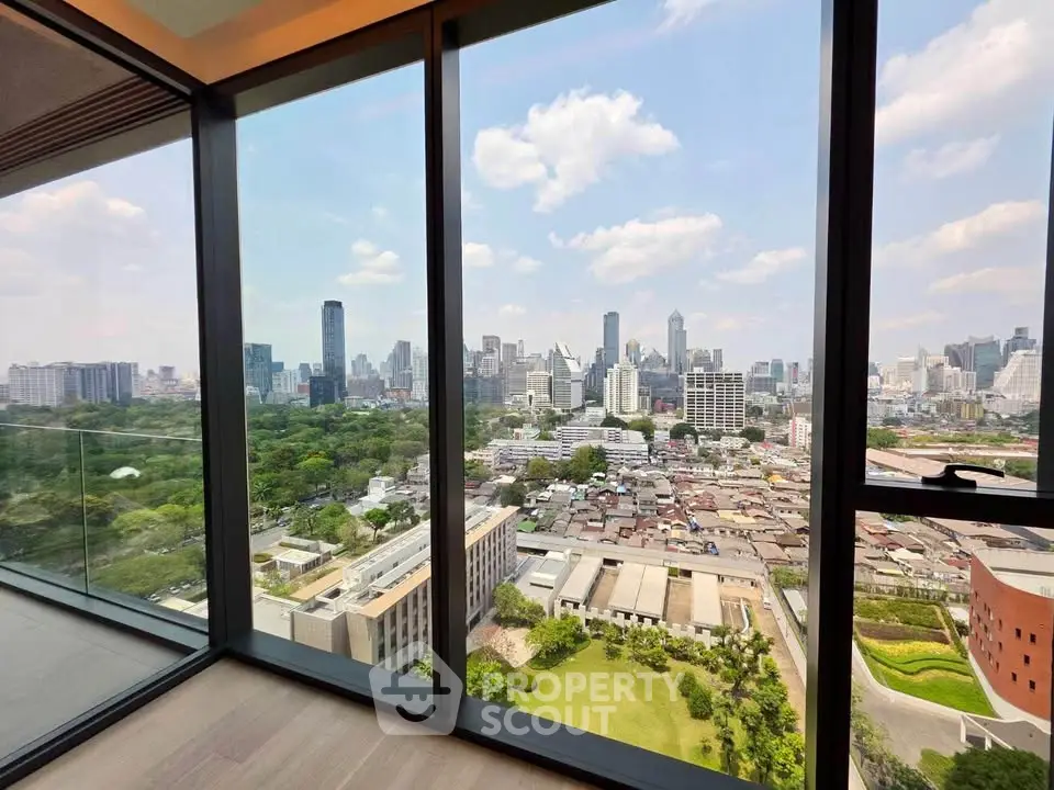 Stunning cityscape view from a modern high-rise apartment with floor-to-ceiling windows.