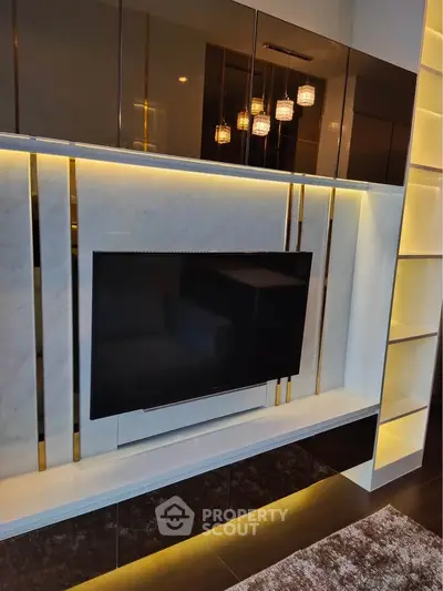 Luxurious living room with modern TV setup and elegant lighting