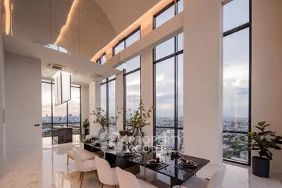 Luxurious high-rise dining area with panoramic city views and elegant decor.