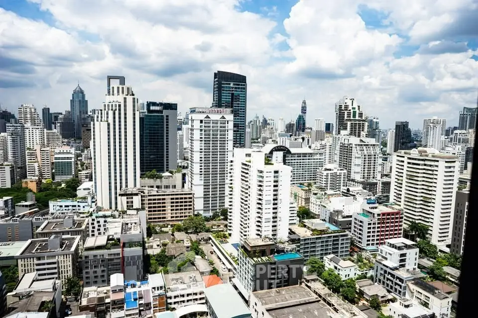 Stunning aerial view of modern city skyline with skyscrapers under a vibrant blue sky.