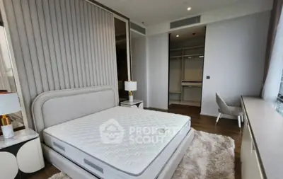 Luxurious bedroom with modern design, featuring a plush bed, elegant decor, and spacious walk-in closet.