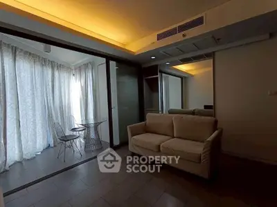 Modern living room with cozy sofa and glass dining set, featuring ambient lighting and floor-to-ceiling curtains.