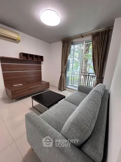 Modern living room with sleek furniture and balcony view