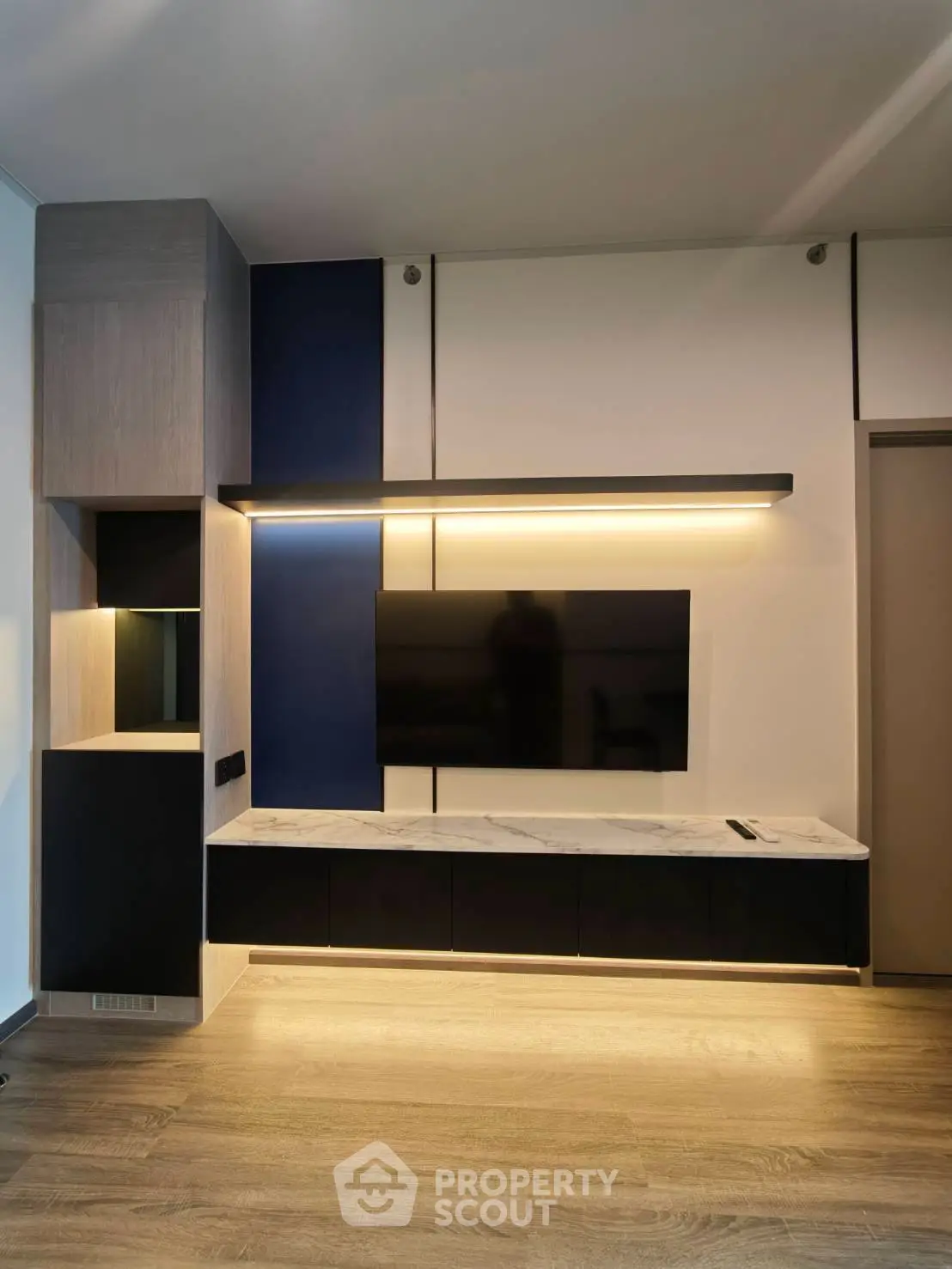 Modern living room with sleek TV unit and ambient lighting