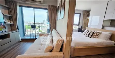 Modern apartment with spacious living room and bedroom, featuring a balcony with stunning city views.