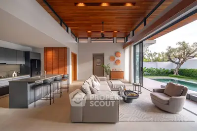 Luxurious open-plan living room with pool view and modern kitchen