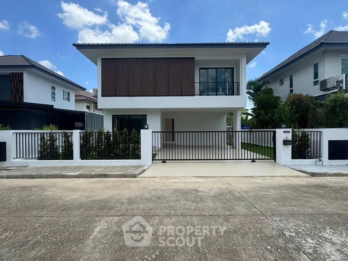 Modern two-story house with sleek design and spacious driveway in a serene neighborhood.