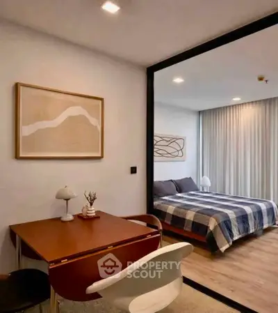 Modern bedroom with stylish decor and study area, featuring elegant furniture and cozy ambiance.