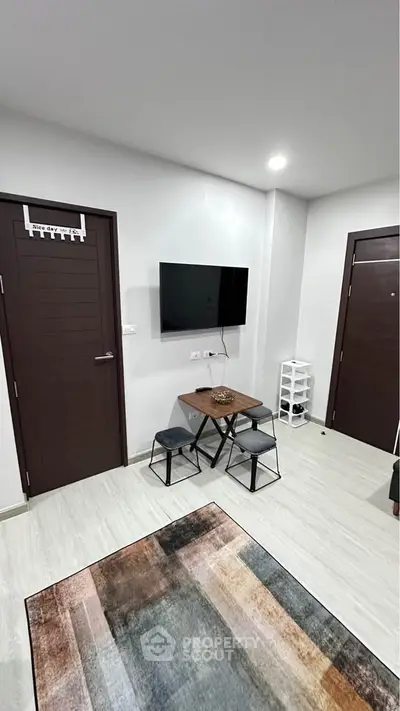 Modern living room with wall-mounted TV and stylish decor