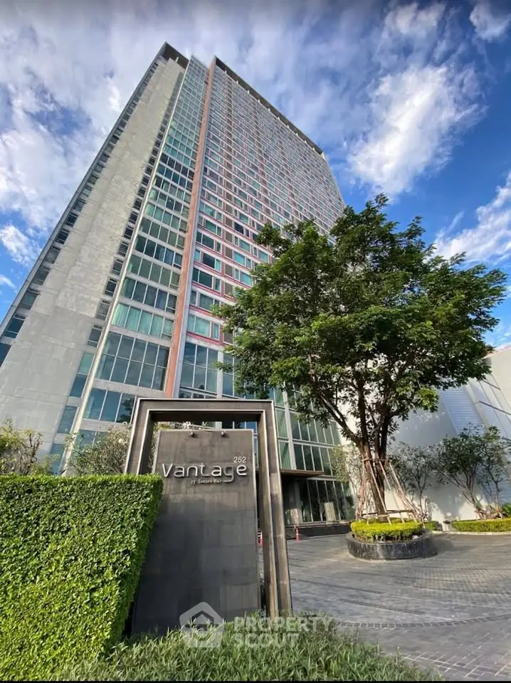 Stunning high-rise building with modern architecture and lush landscaping, perfect for urban living.
