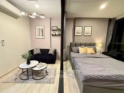 Modern studio apartment with cozy living area and stylish bedroom