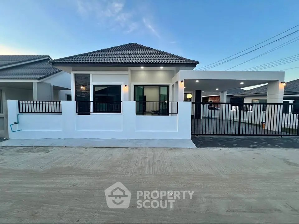 Modern single-story house with sleek design and spacious driveway in a serene neighborhood.