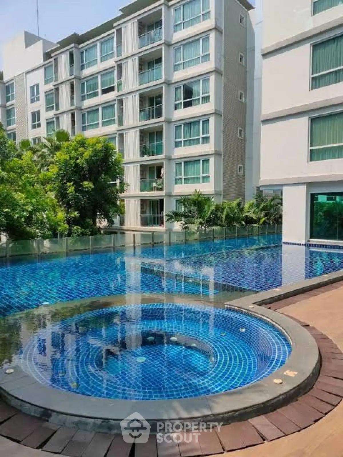 Luxurious apartment complex with stunning pool and modern architecture.