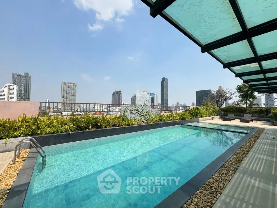 Luxurious rooftop pool with stunning city skyline views, perfect for relaxation and leisure.