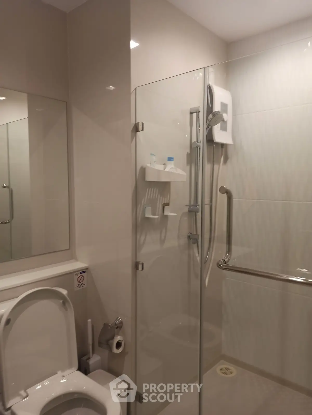 Modern bathroom with glass shower enclosure and sleek fixtures