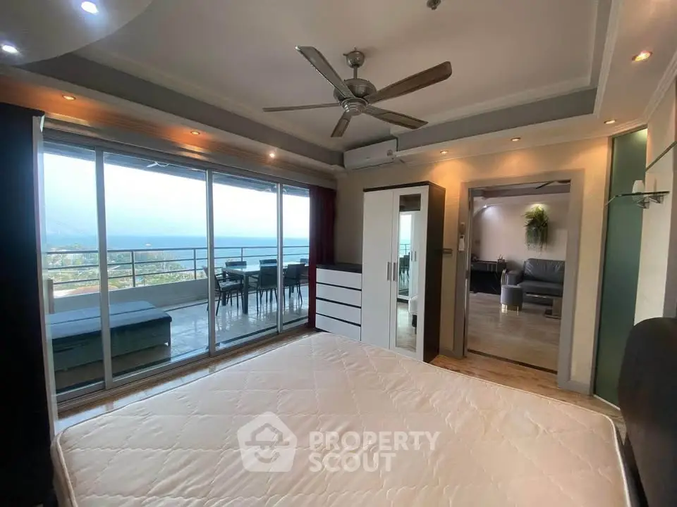 Spacious bedroom with balcony offering stunning sea views and modern interior design.