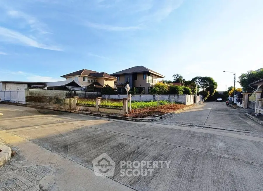 Charming suburban neighborhood with spacious homes and clear blue skies.