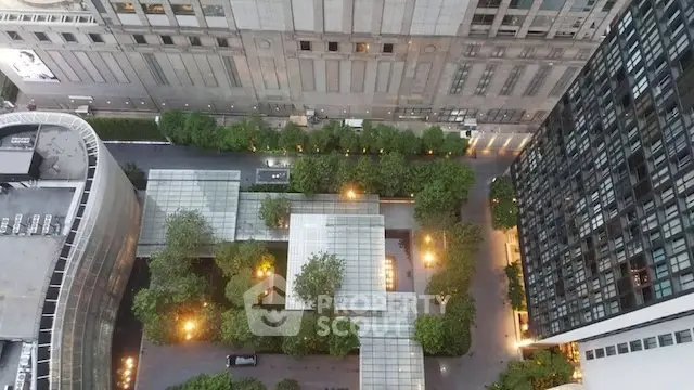 Stunning aerial view of urban courtyard with lush greenery and modern architecture.