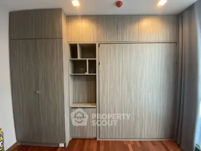 Modern built-in storage unit with sleek wood finish in a stylish interior space.