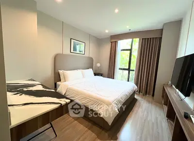 Spacious modern bedroom with large window and stylish decor
