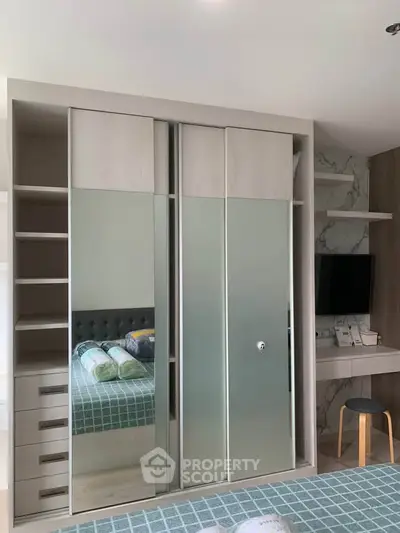 Modern bedroom with mirrored wardrobe and stylish decor