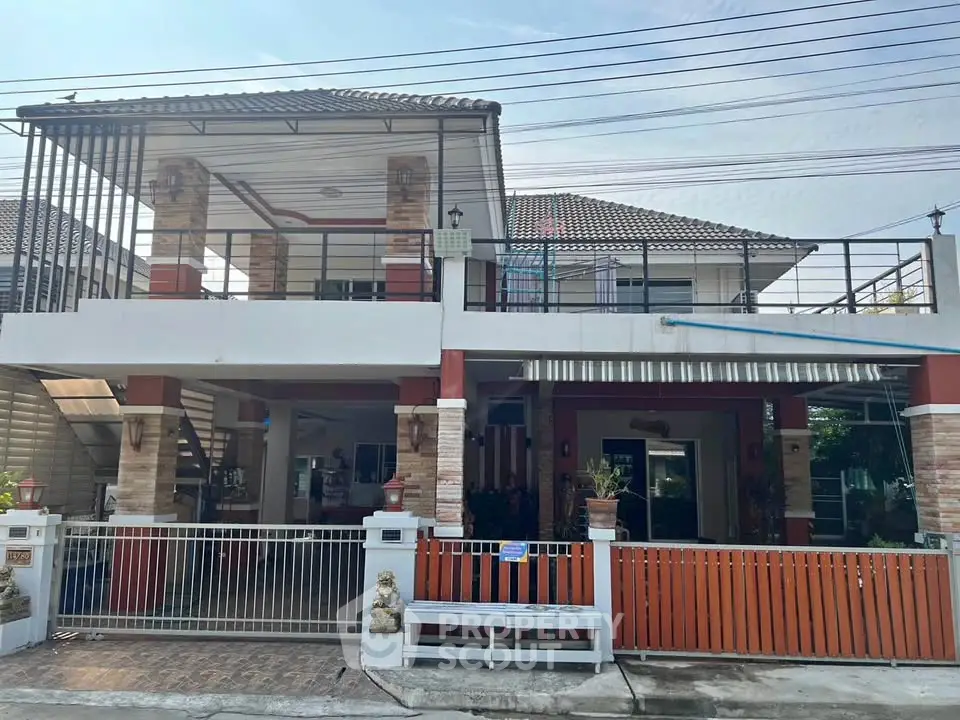 Charming two-story house with spacious balcony and modern design in a serene neighborhood.