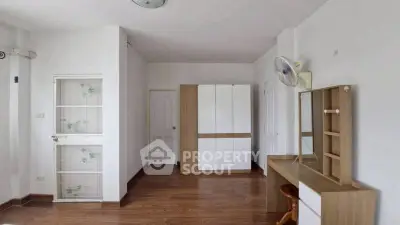 Spacious bedroom with modern furniture and wooden flooring