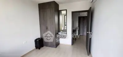 Modern bedroom with sleek wardrobe and minimalist decor in a contemporary apartment.