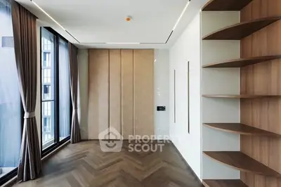 Modern living room with large windows and stylish wooden shelves