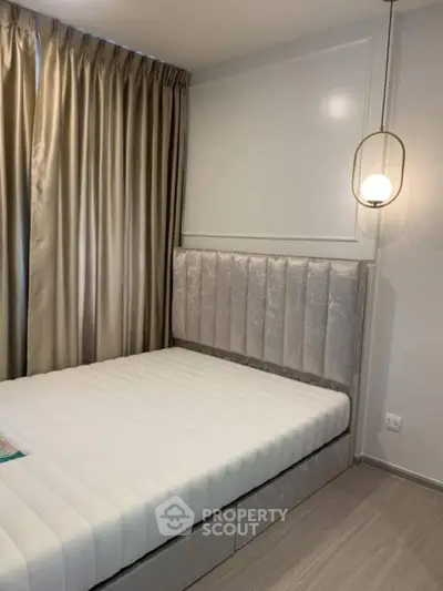 Modern bedroom with elegant lighting and plush headboard