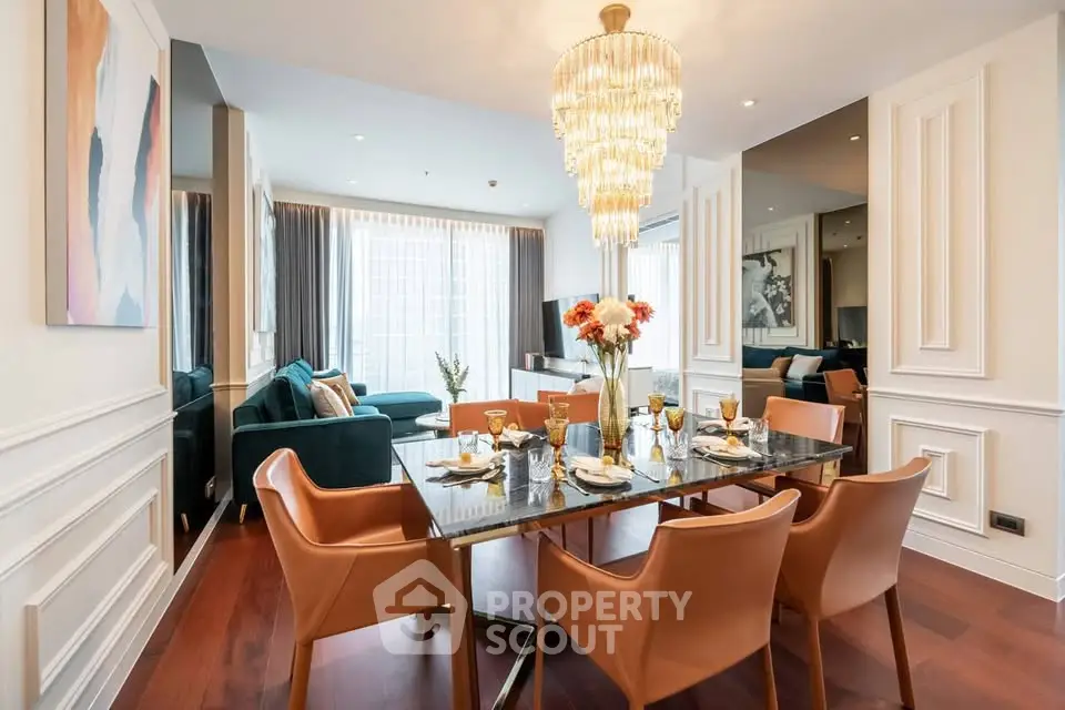 Luxurious dining and living area with elegant chandelier and modern decor