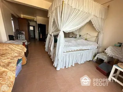 Spacious bedroom with elegant canopy bed and cozy decor