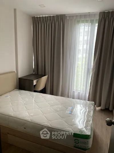 Cozy bedroom with natural light and modern furnishings, ideal for urban living.
