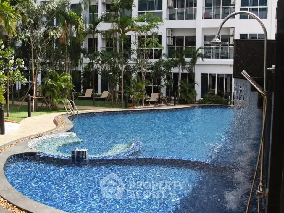 Luxurious residential pool with modern design and lush greenery, perfect for relaxation and leisure.