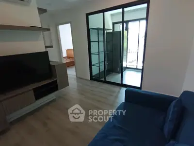 Modern living room with sliding glass doors and sleek furniture