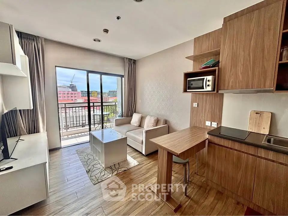 Modern studio apartment with open kitchen and balcony view