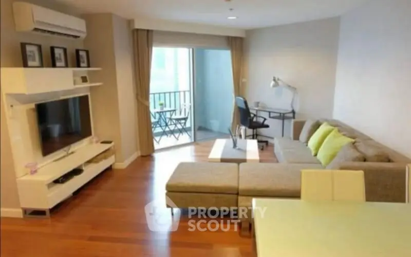 Spacious living room with modern decor and balcony access