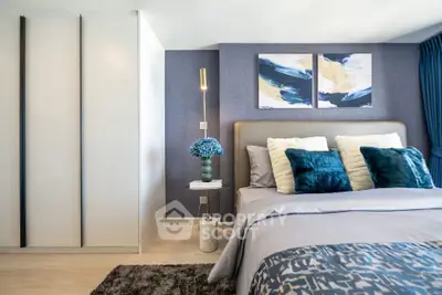 Luxurious bedroom with modern decor, plush bedding, and stylish artwork for a serene living experience.