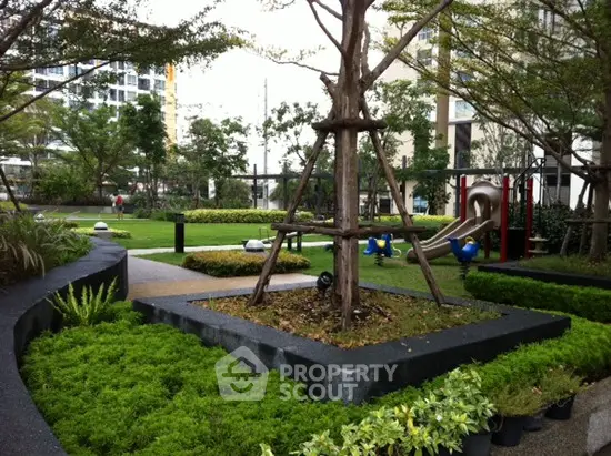 Lush garden area with playground in modern residential complex