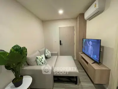Modern living room with cozy sofa, TV, and air conditioning in stylish apartment.