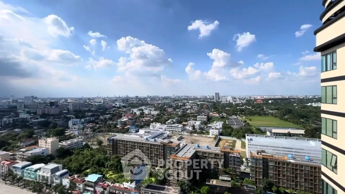 Stunning cityscape view from high-rise building with clear blue sky.
