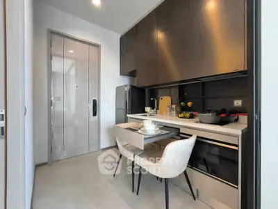 Modern kitchen with sleek cabinets and dining setup, featuring a compact and stylish design.