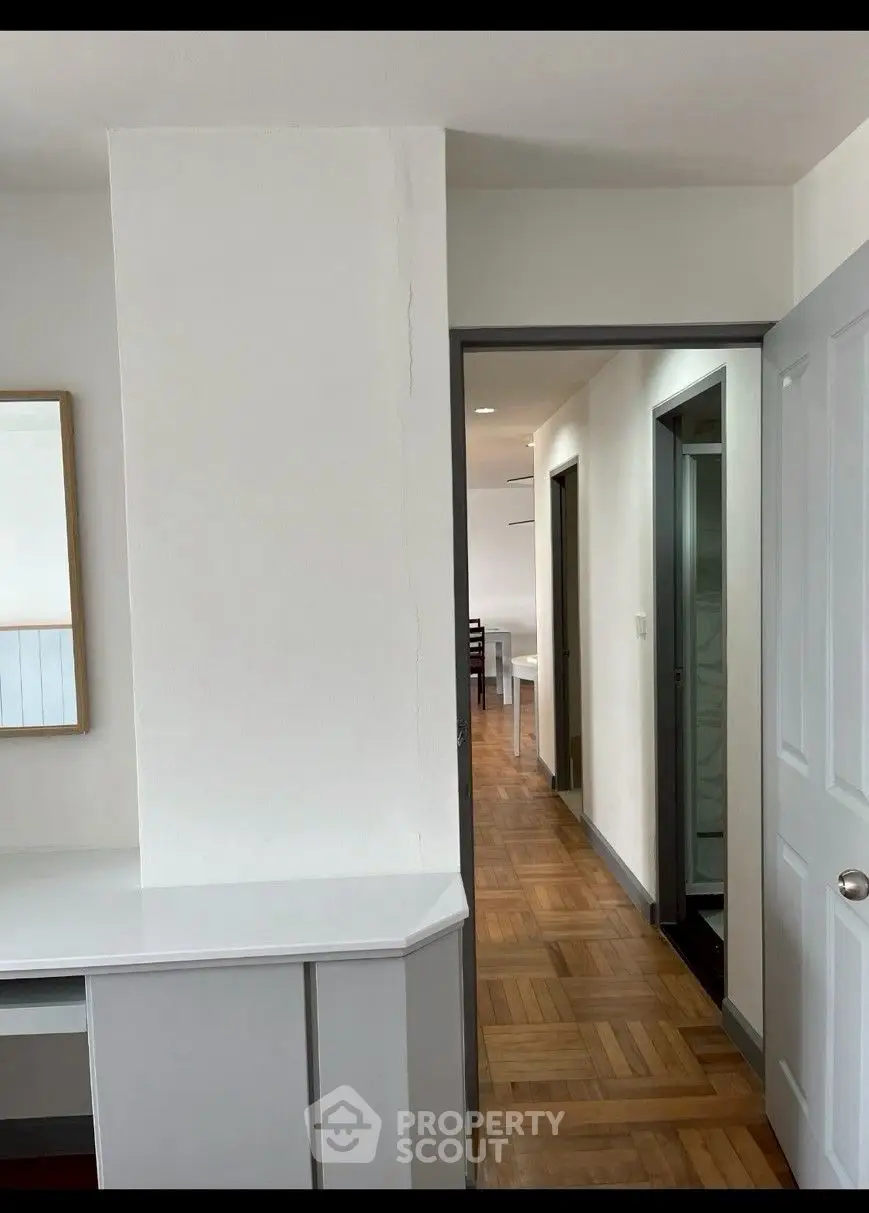Spacious interior hallway with wooden flooring and modern decor