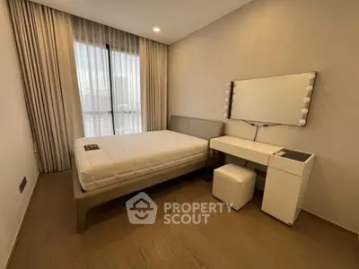 Modern bedroom with stylish furniture and natural light, perfect for a cozy living experience.