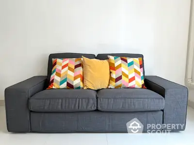 Stylish modern sofa with colorful cushions in a bright living room