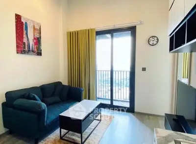 Modern living room with balcony view, stylish decor, and comfortable seating in a bright apartment.